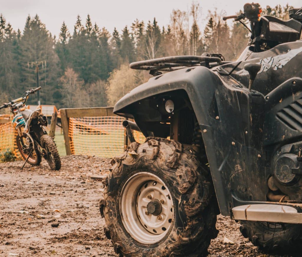 An ATV rider crossing mud, FortNine cover